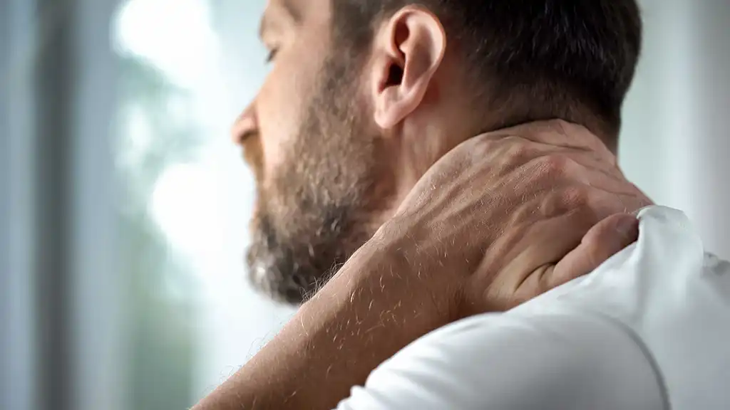 man grabbing his neck from an auto injury