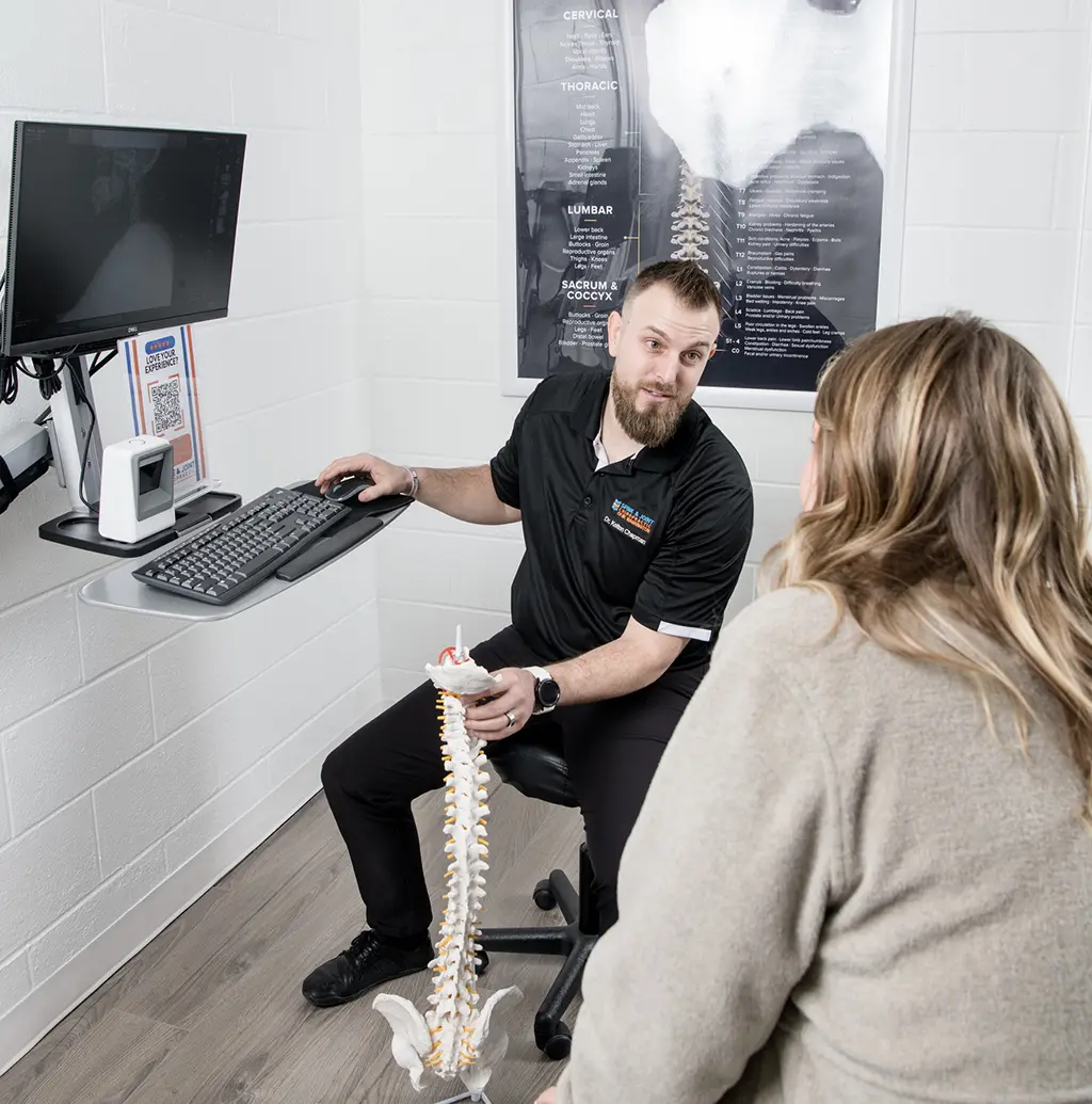 Dr. Chapman explaining something to a patient at Spine and Joint Chiropractor Office