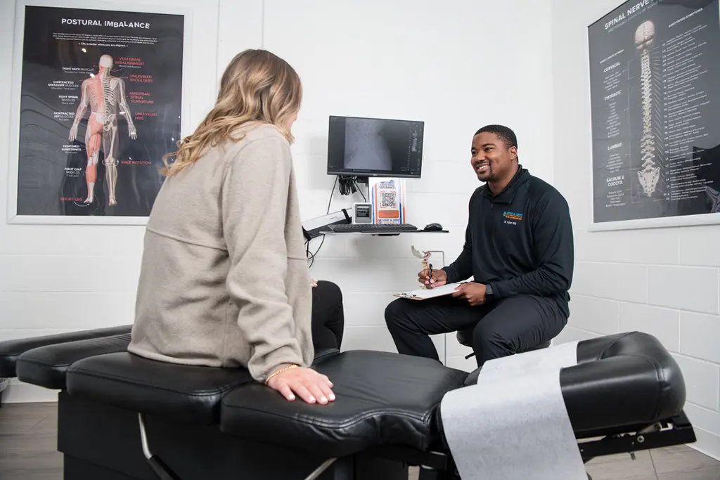 patient talking with chiropractor at Spine and Joint Chiropractor Office