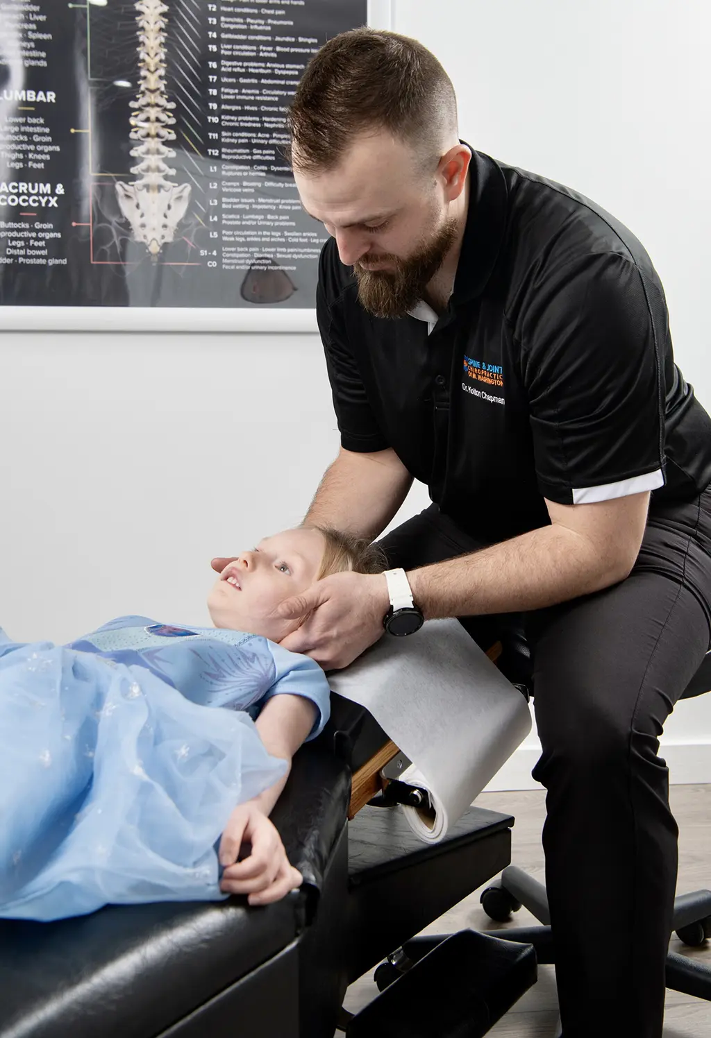 Dr. Chapman working with a child at Spine and Joint Chiropractor Office