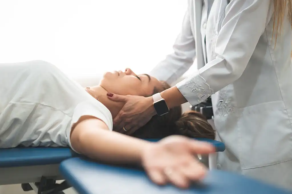 woman having neck adjusted for migraines